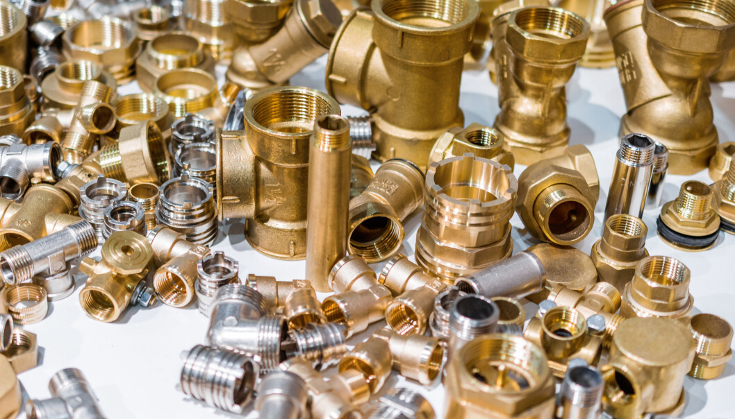 Scattering of various brass sanitary products. Abstract industrial background. Scattering of various brass sanitary products. Abstract industrial background.